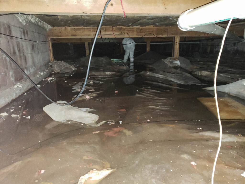 A crawl space filled with water after a pipe break
