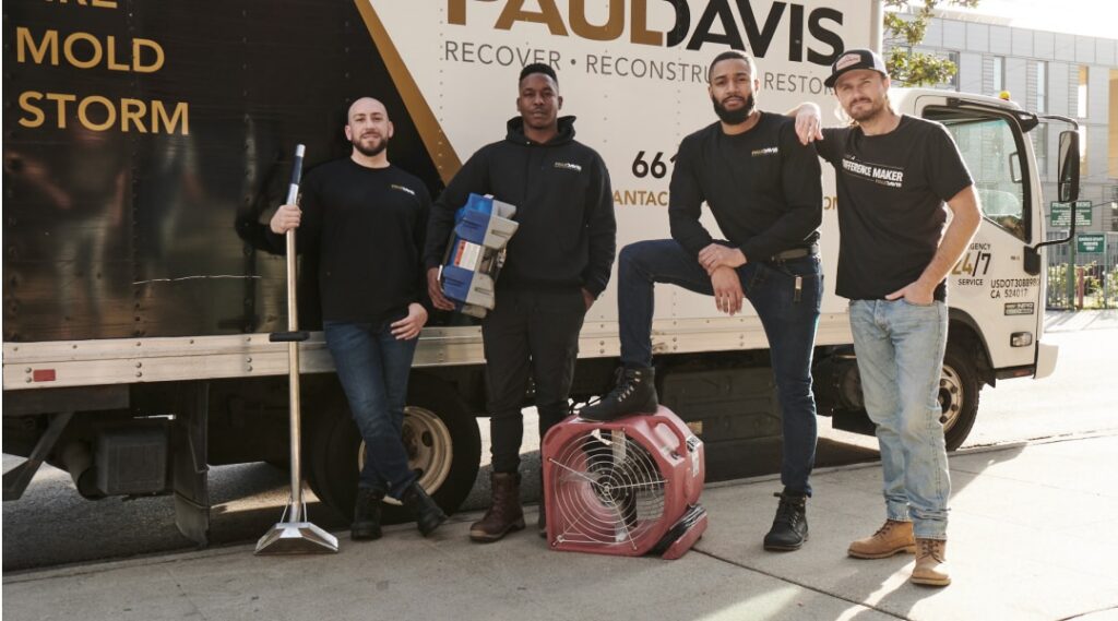 Paul Davis Restoration team in Lynchburg, Roanoke & Southside VA standing in front of service truck with restoration equipment, ready for water, mold, and storm damage response.